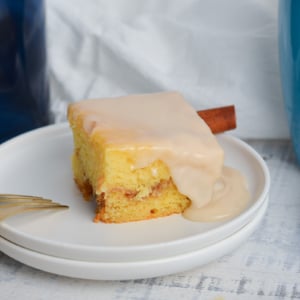 angled shot of slice of honey bun cake on plate