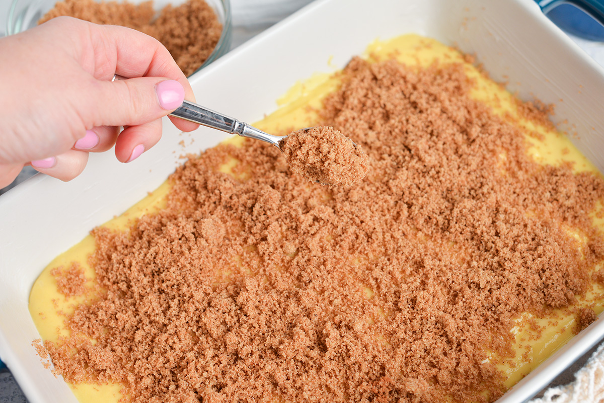 spoon adding cinnamon layer to cake batter