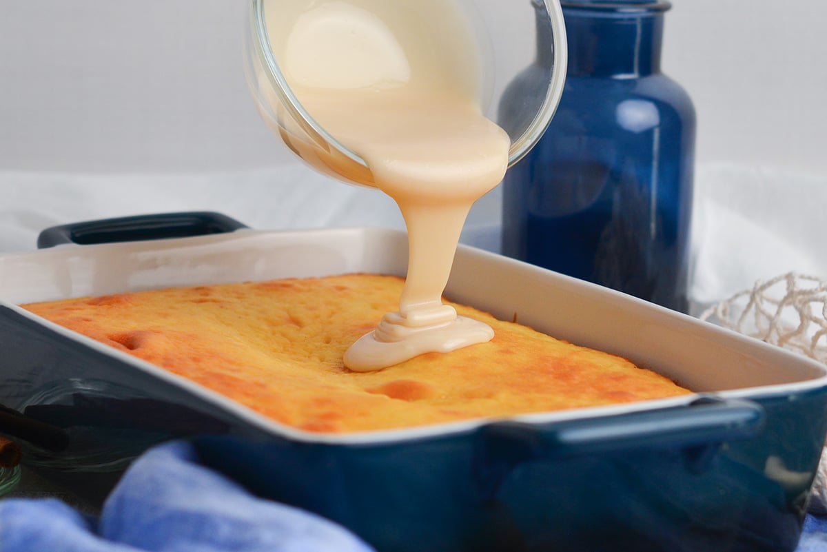 icing pouring from bowl onto cake