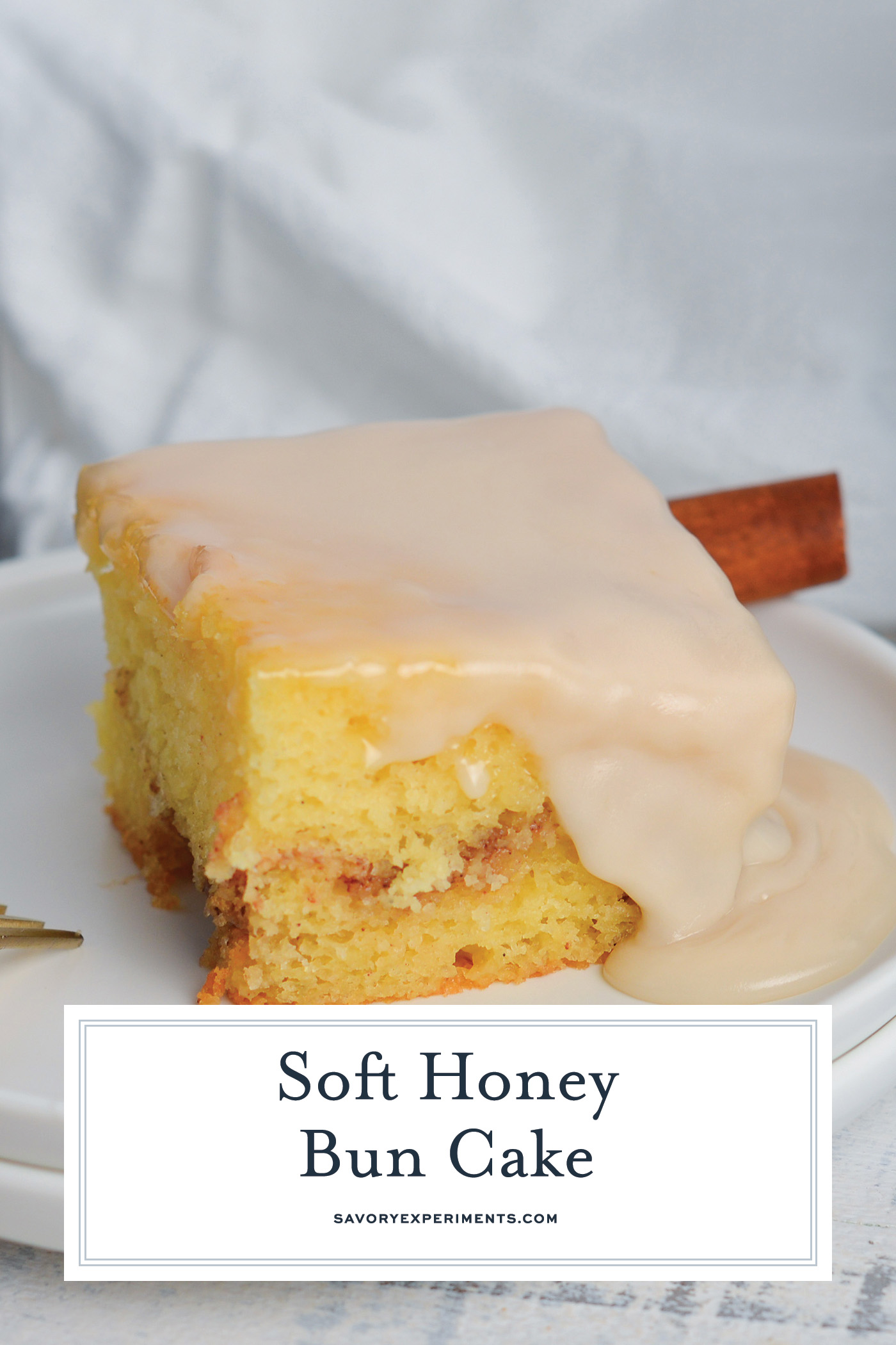 angled shot of slice of honey bun cake on plate with text overlay