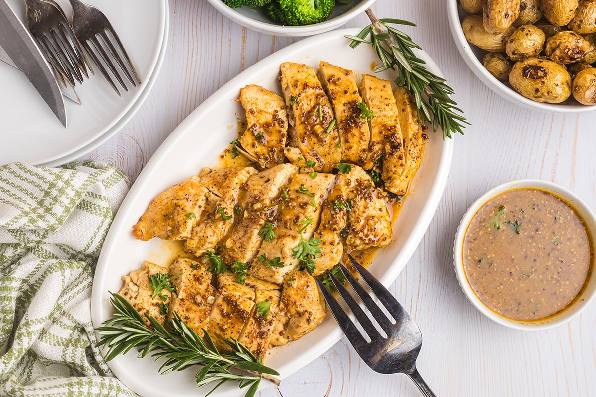 overhead shot of sliced honey mustard chicken on platter