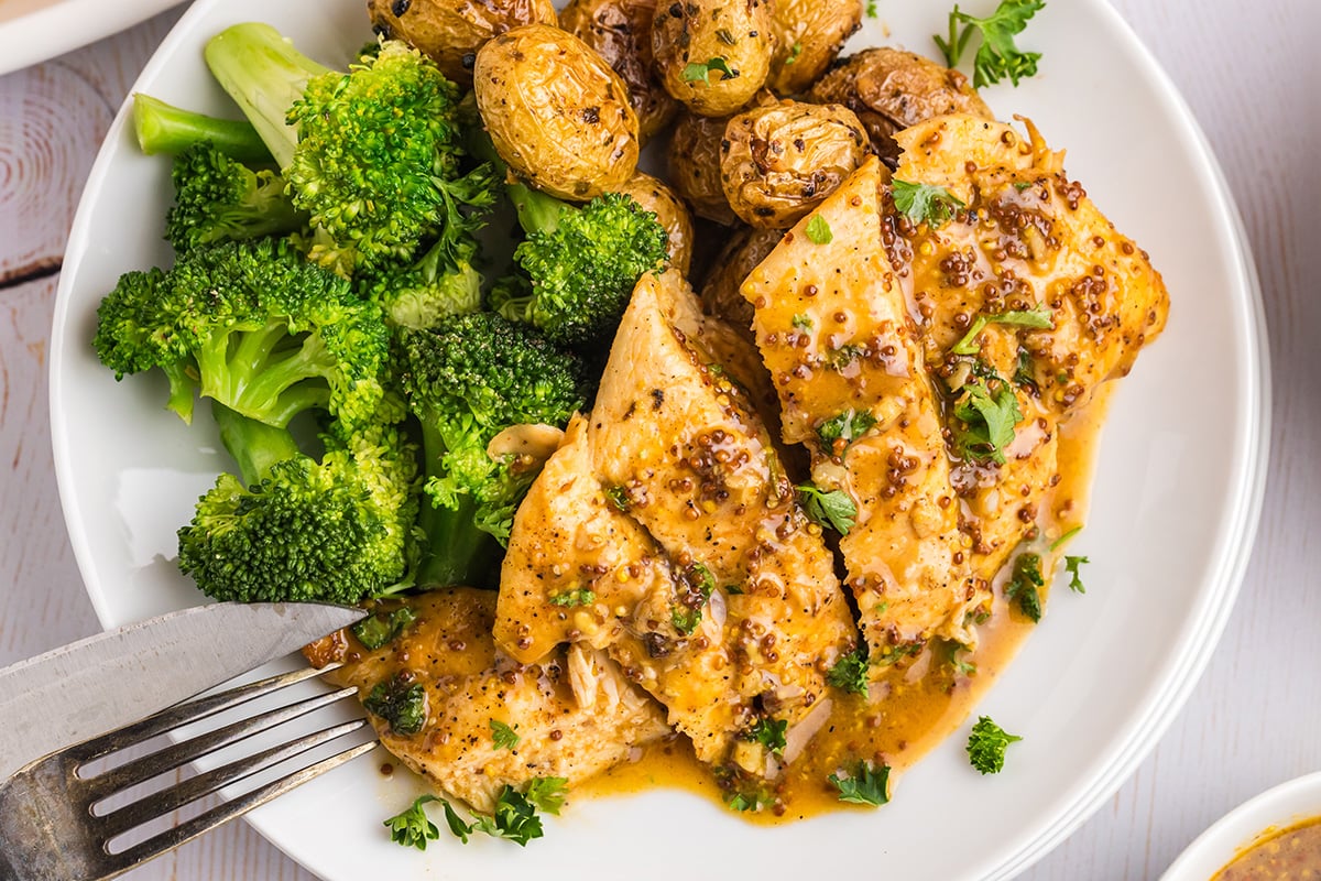 overhead shot of sliced honey mustard chicken on plate