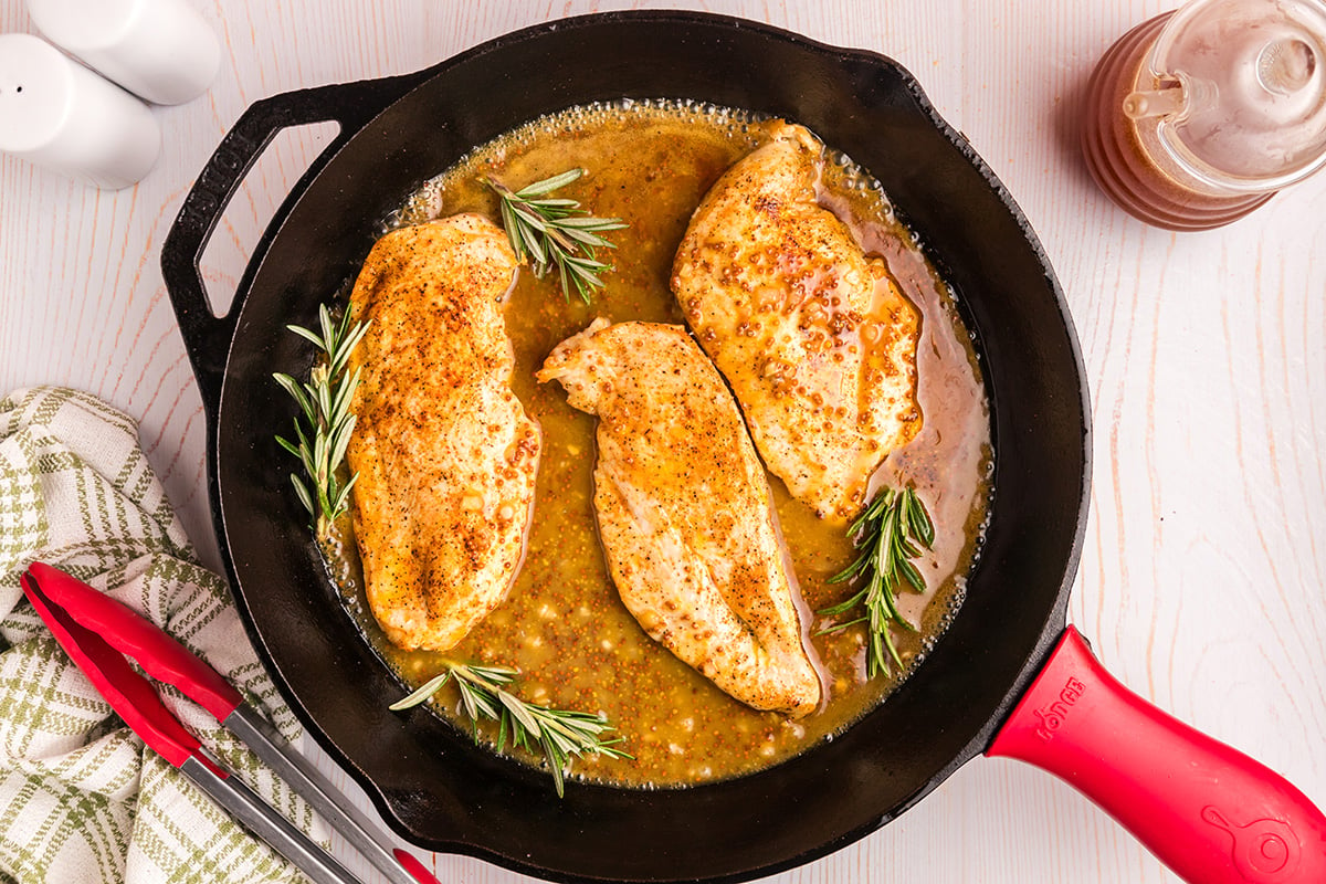 overhead shot of honey mustard chicken in skillet