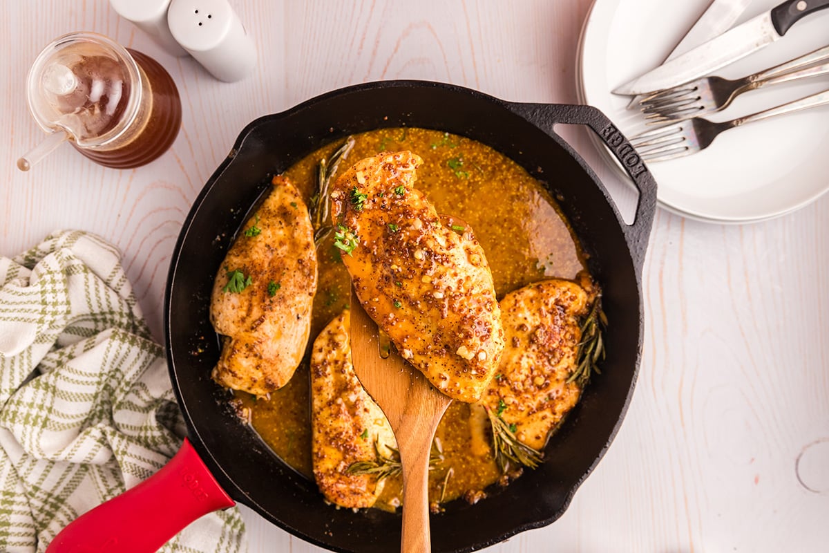 overhead shot of honey mustard chicken on wooden spoon