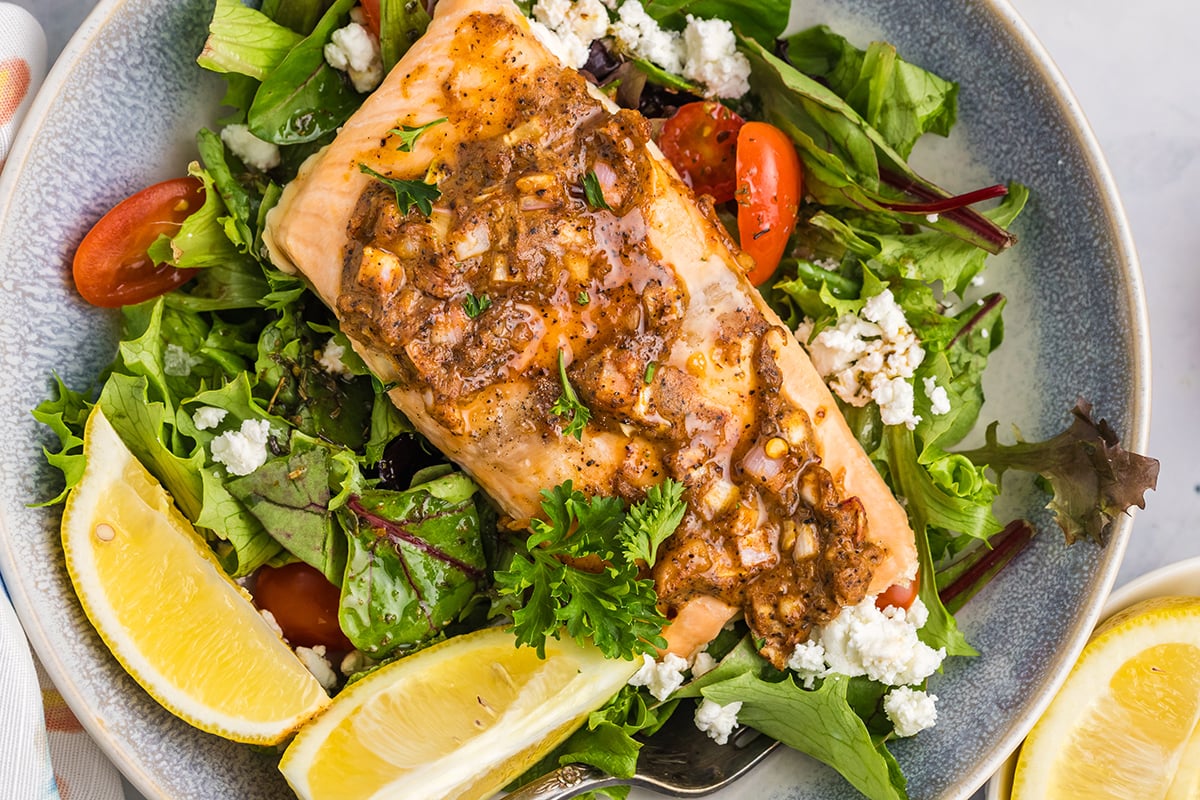 close up overhead shot of hot honey salmon on salad