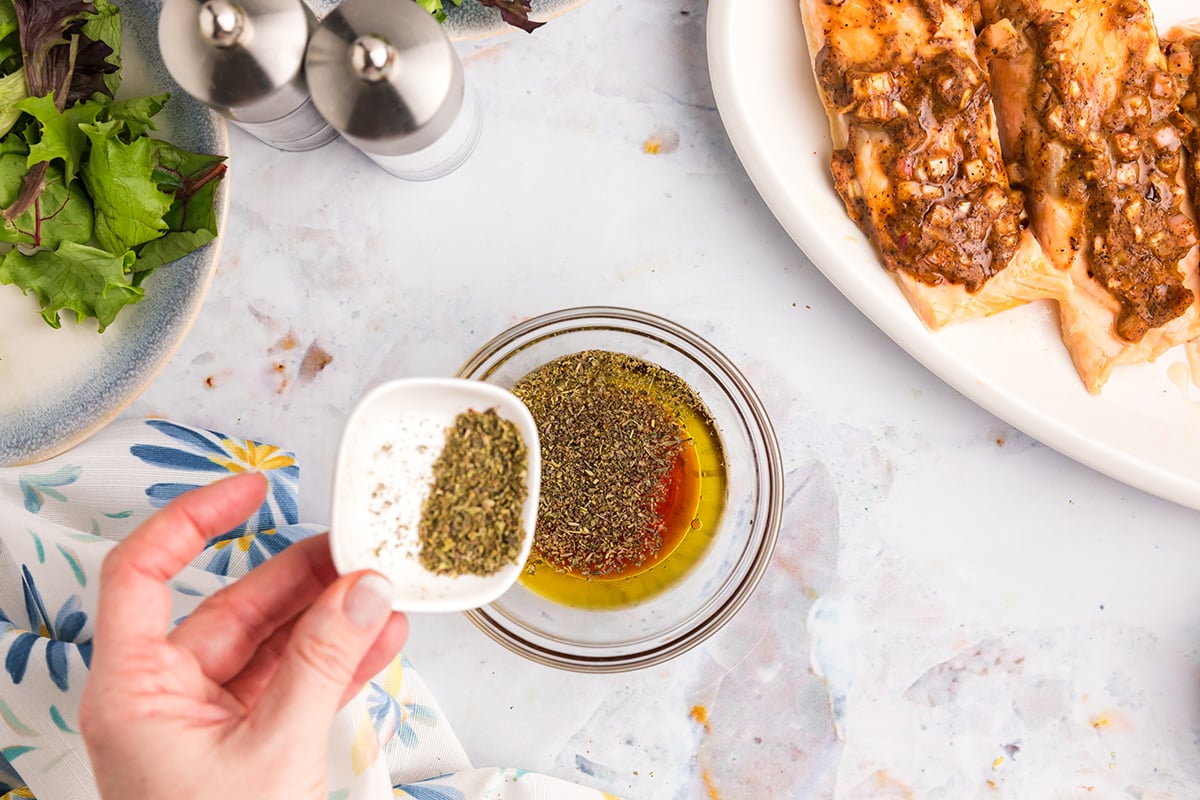 seasoning added to bowl of dressing