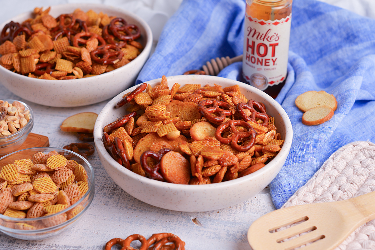 angled shot of bowl of hot honey snack mix