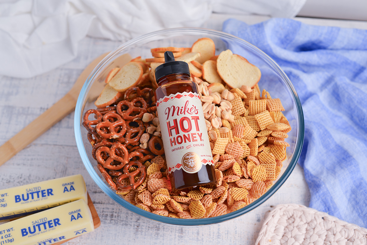 jar of hot honey in bowl of chex mix