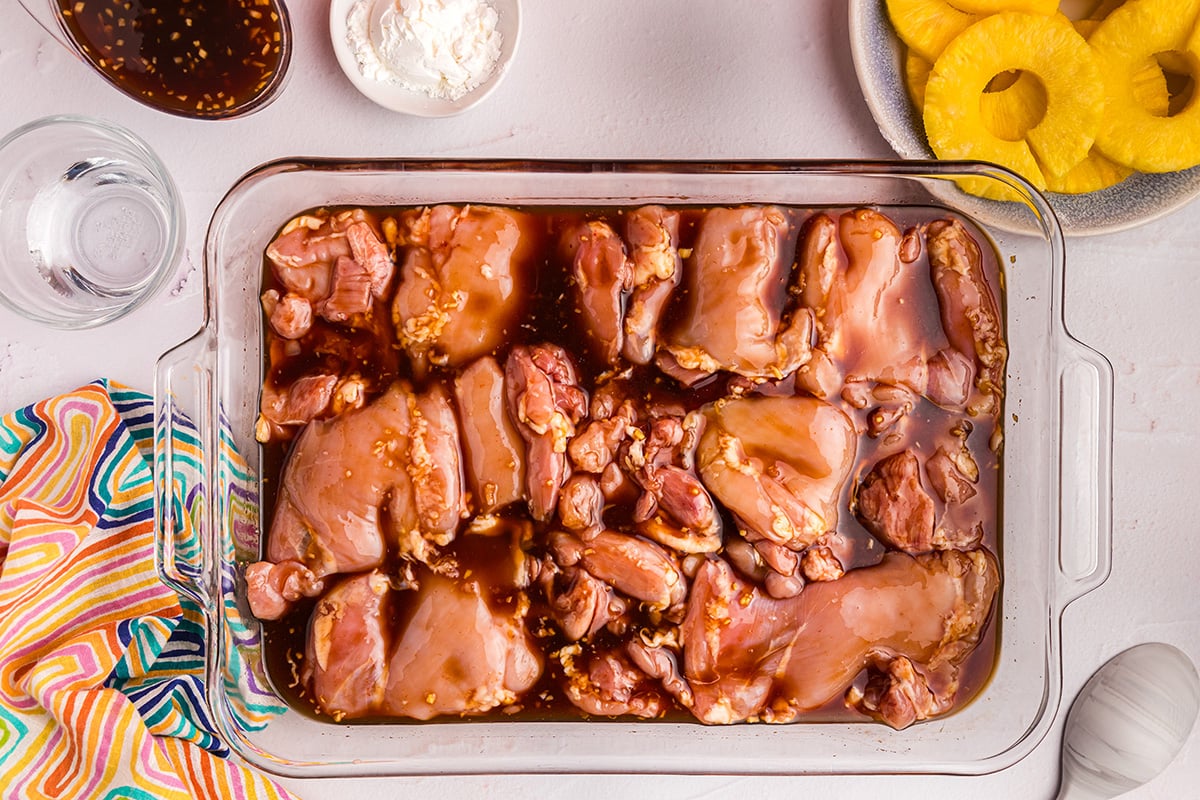 overhead shot of raw chicken marinating in huli huli sauce