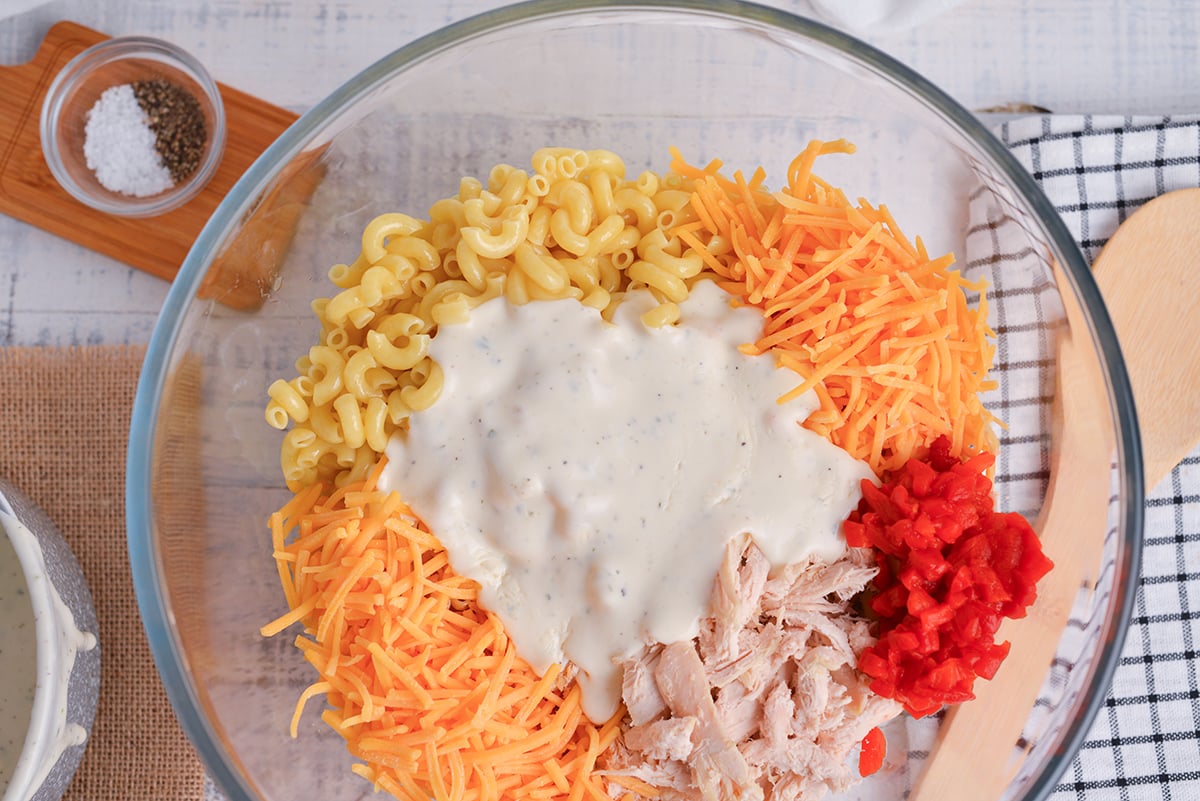 ranch added to chicken noodle casserole ingredients in bowl
