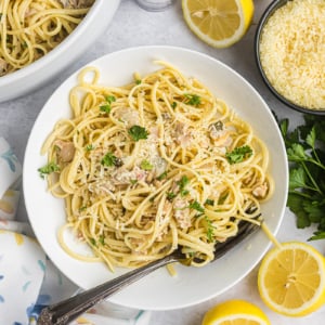 overhead shot of fork in bowl of linguine with white clam sauce