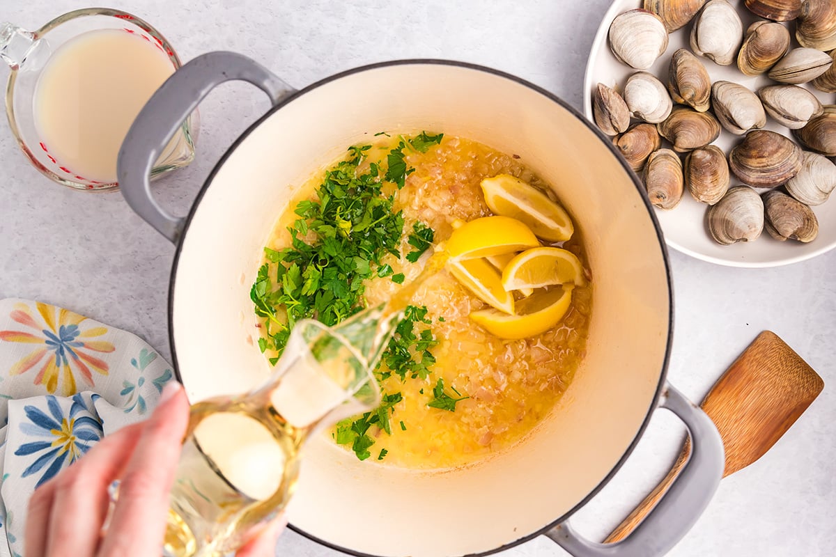 overhead shot of wine poured into pot of butter sauce