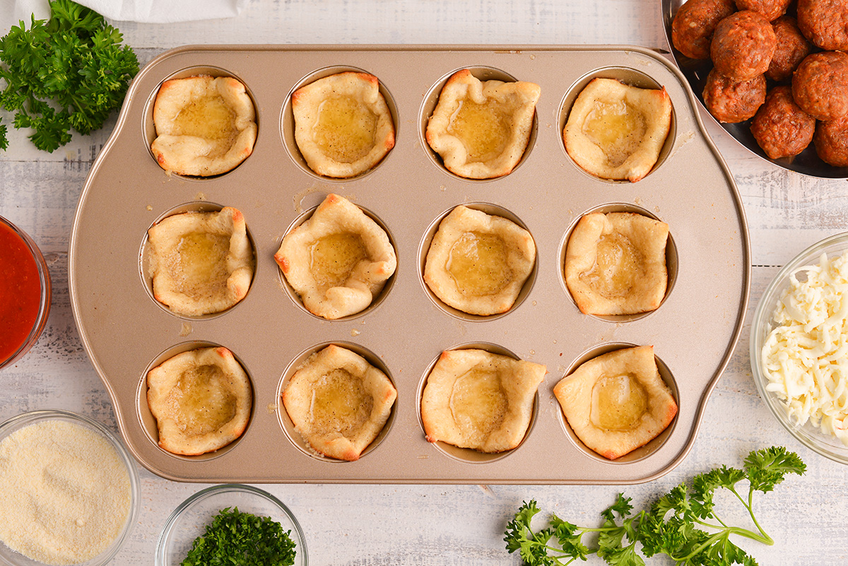 pizza dough in muffin tin