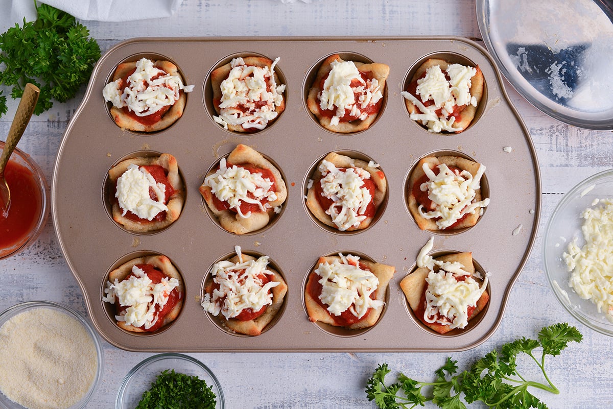 cheese sprinkles onto meatball bombs