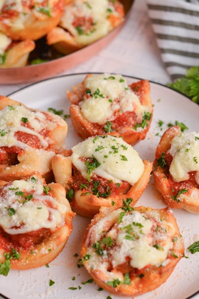 angled shot of plate of cheesy meatballs bombs