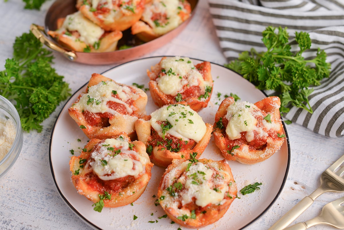 angled shot of plate of cheesy meatballs bombs