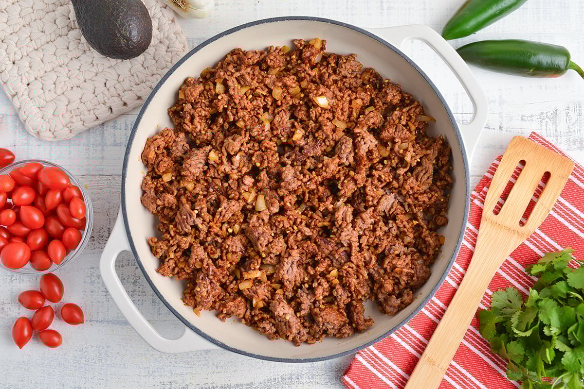 ground beef and onions cooking in pan