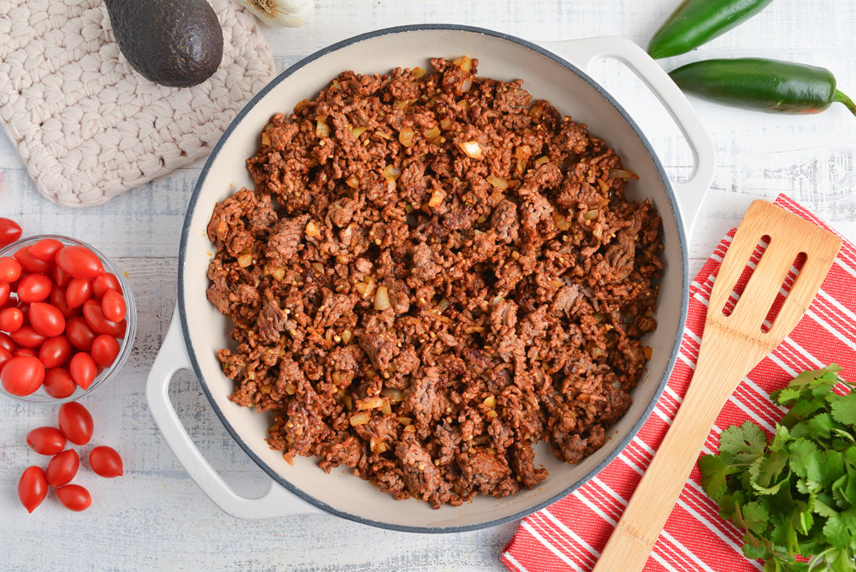 ground beef and onions cooking in pan