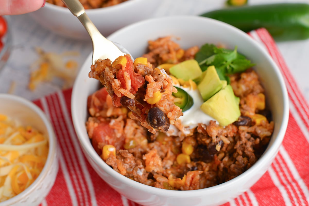 close up of mexican rice and beef on fork