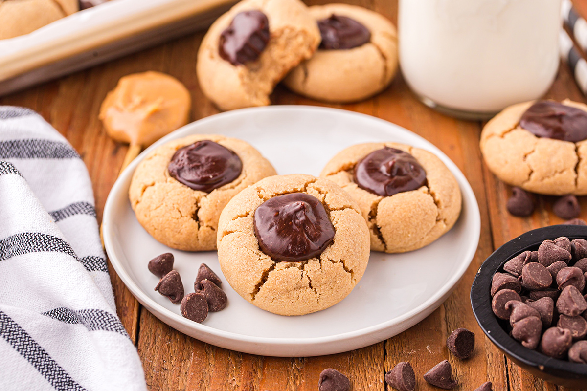 angled shot of three thumbprint cookies on a plate