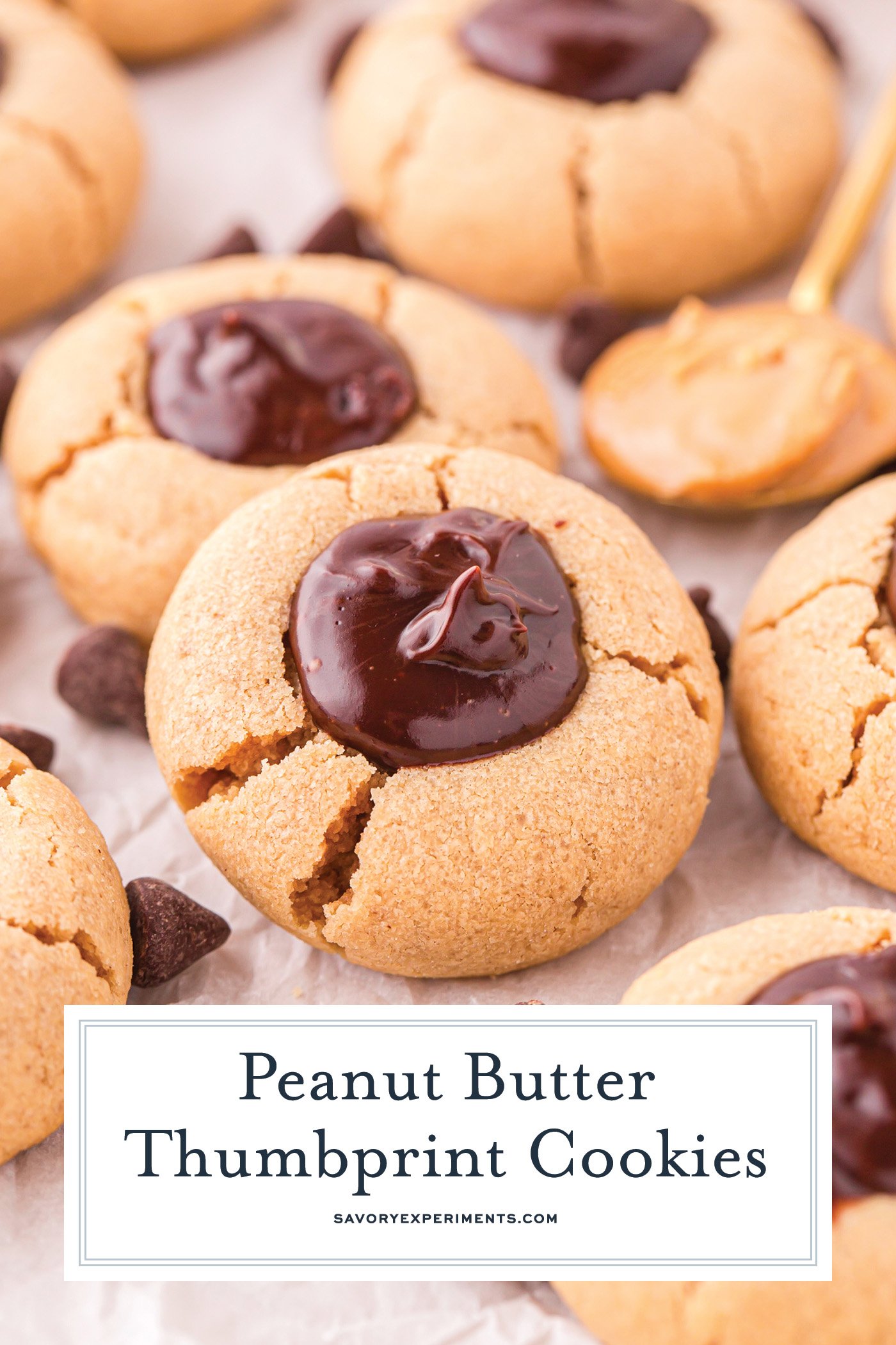 angled shot of peanut butter thumbprint cookies on parchment paper with text overlay