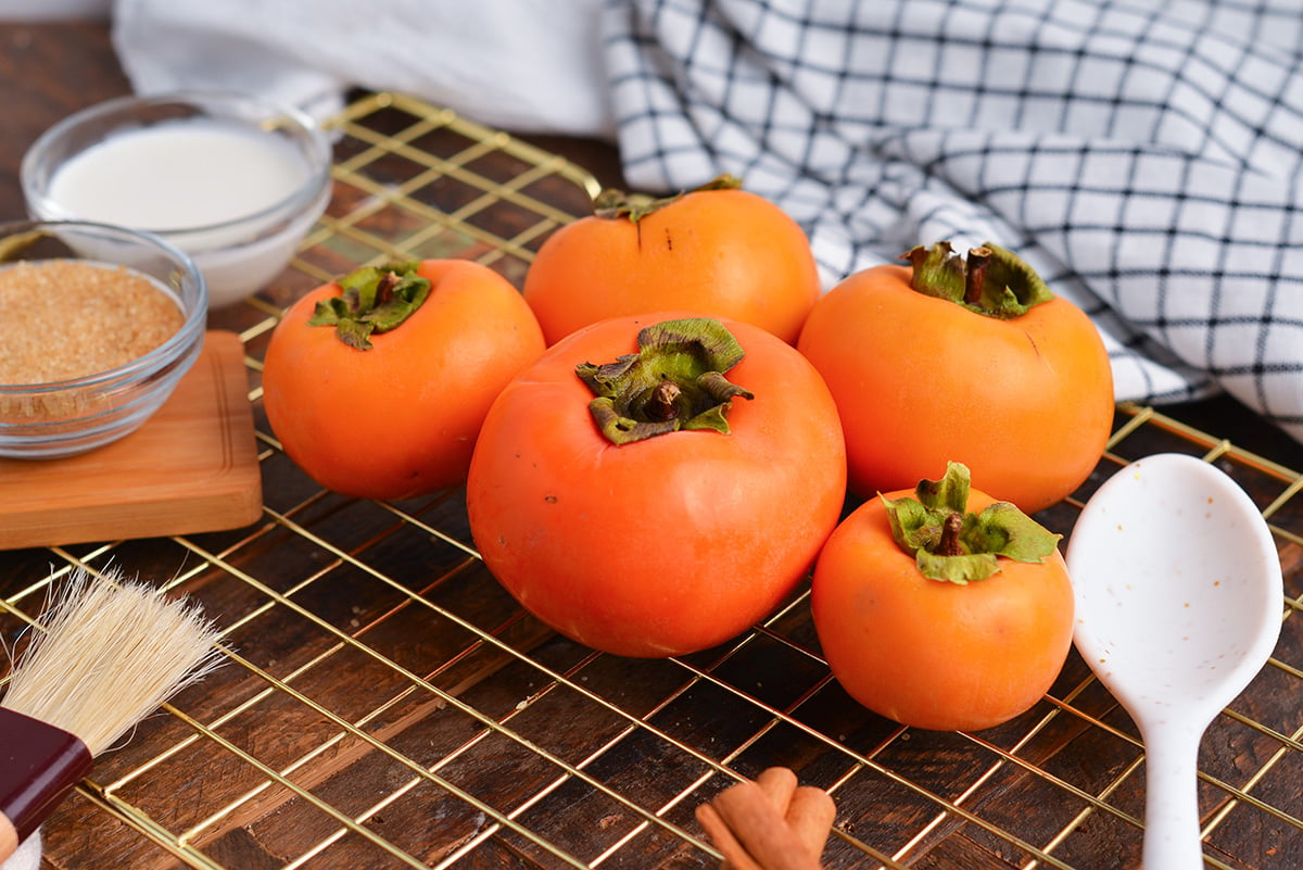 angled shot of persimmons on cooling rack