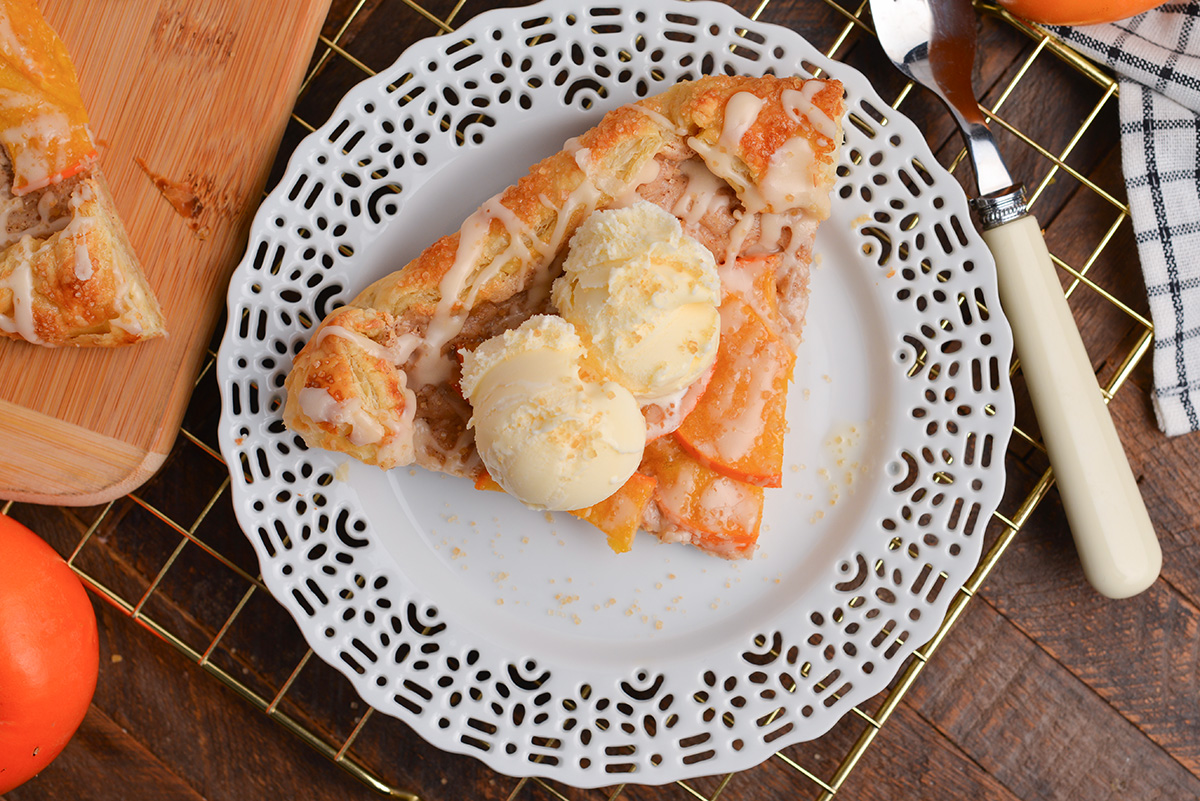 overhead shot of slice of persimmon pastry on white plate