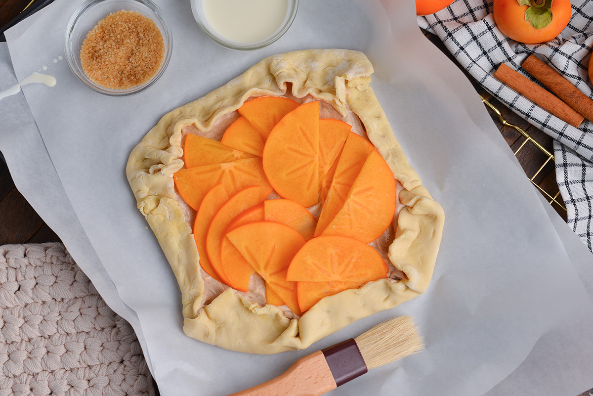 overhead shot of raw persimmon pastry on parchment paper