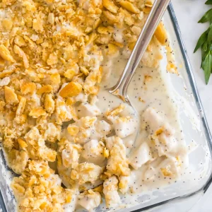 overhead shot of serving spoon in poppy seed chicken casserole