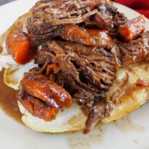 angled shot of pot roast over potatoes