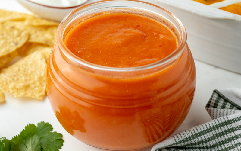 angled shot of jar of homemade enchilada sauce