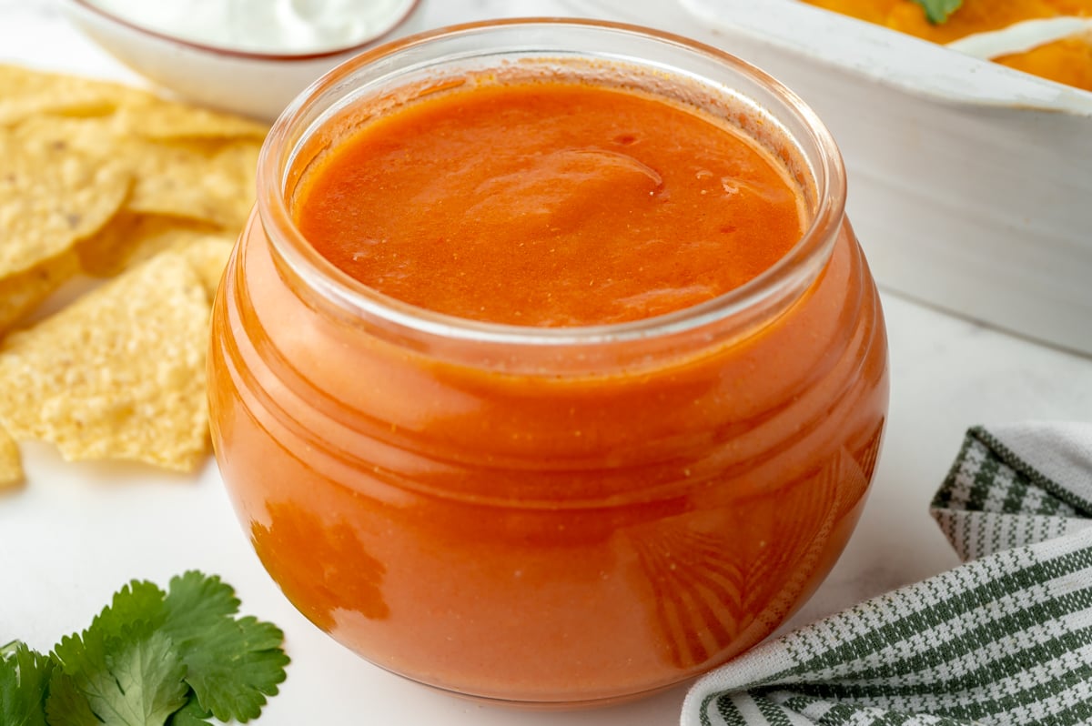 angled shot of jar of homemade enchilada sauce