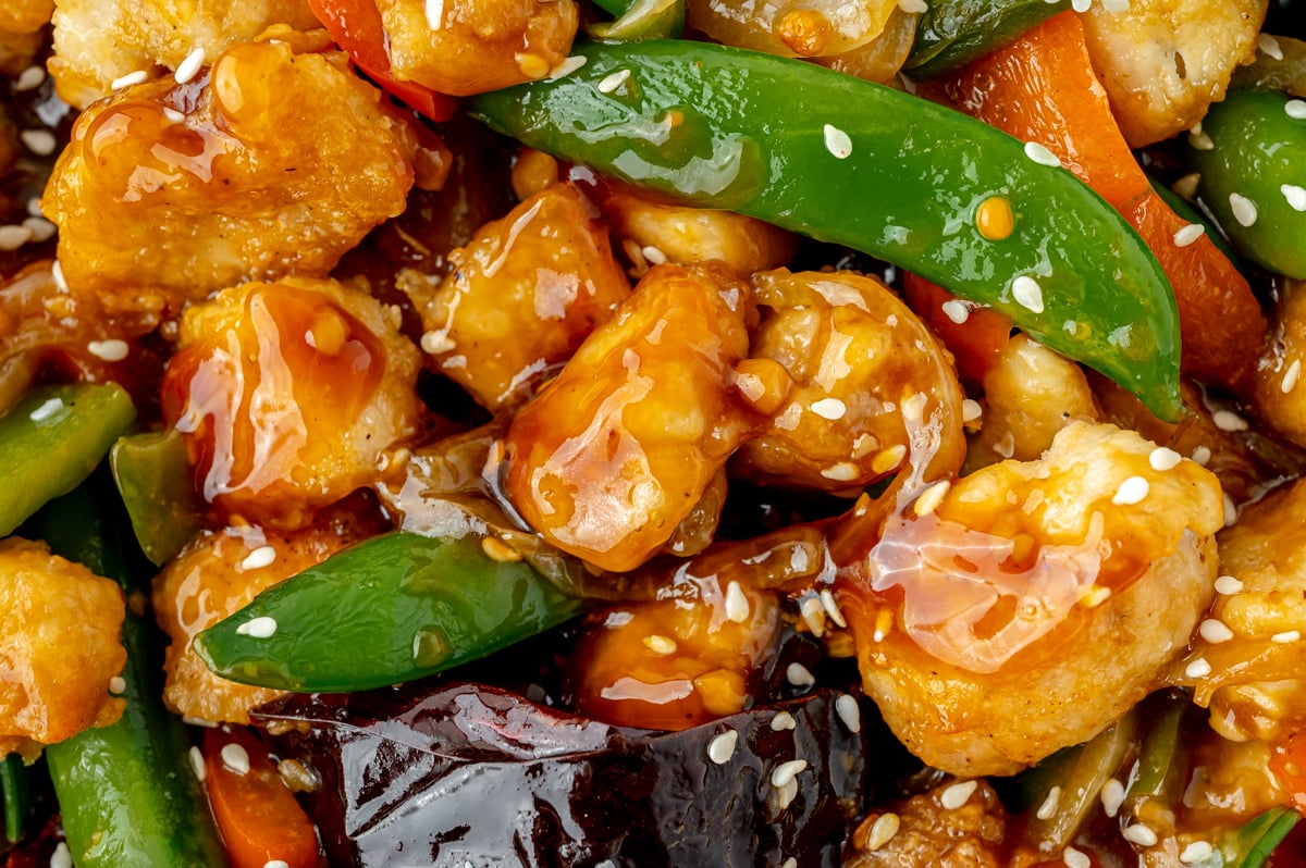 close up overhead shot of szechuan chicken and veggies in pan