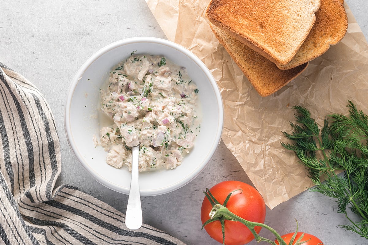 overhead shot of tuna salad in a white bowl