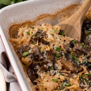 angled shot of wooden spoon in chicken casserole