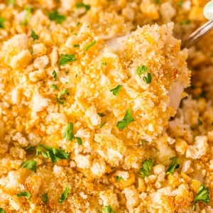 overhead shot of spoon in chicken rice casserole