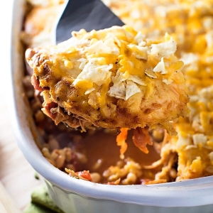 angled shot of serving spoon in chicken taco casserole