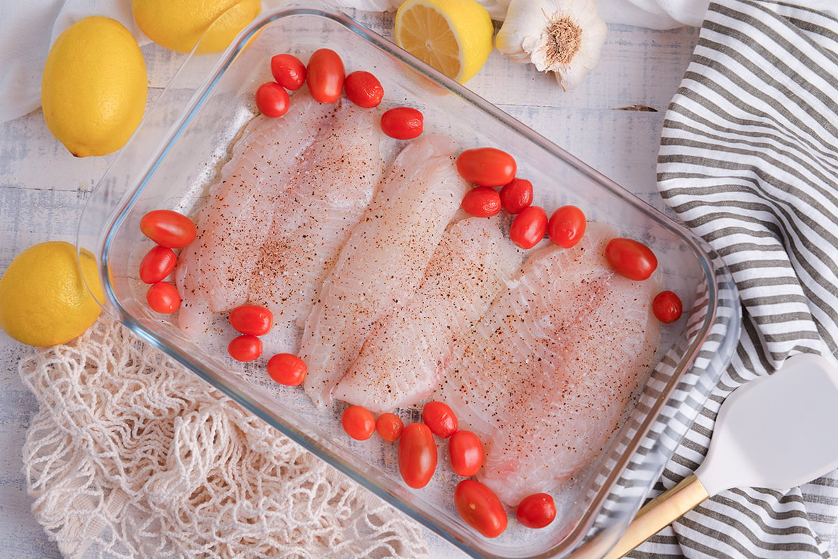 tilapia and tomatoes in baking dish