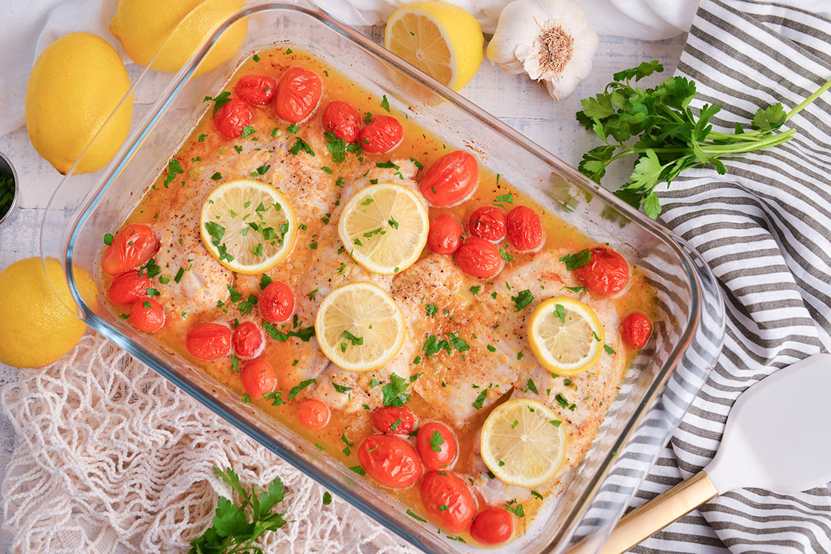 overhead shot of lemon garlic butter baked tilapia in baking dish