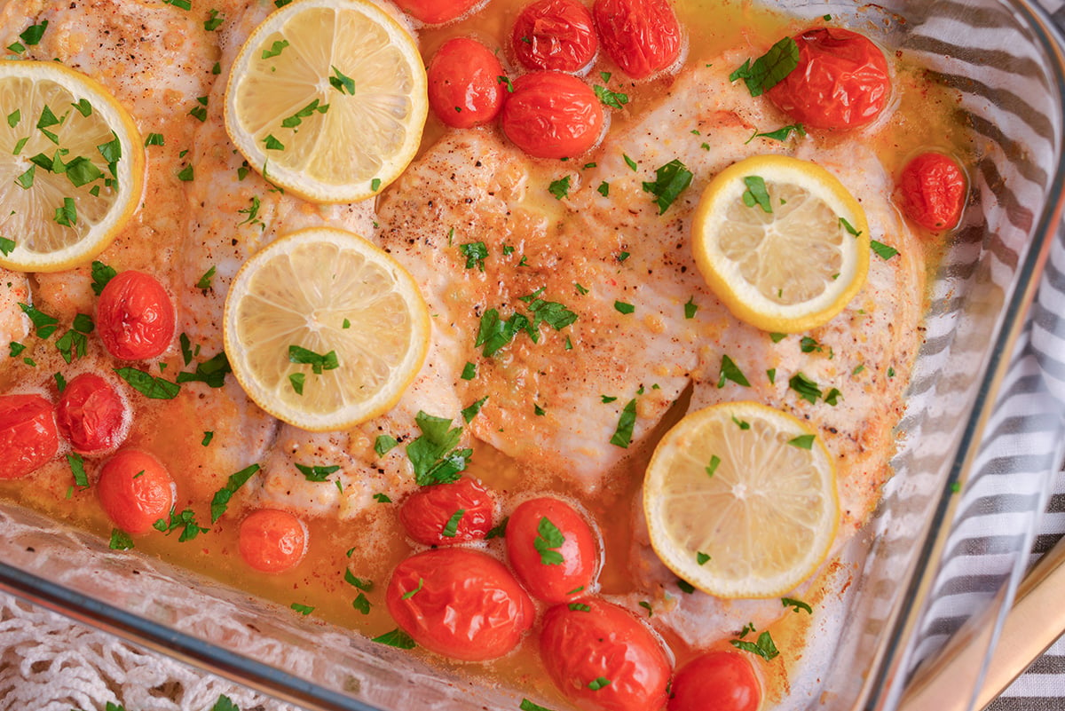 close up shot of baked tilapia in baking dish