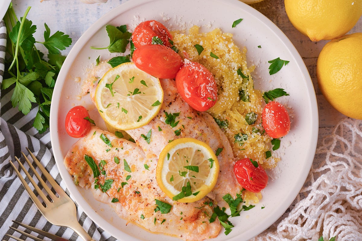 overhead shot of lemon garlic butter baked tilapia on plate