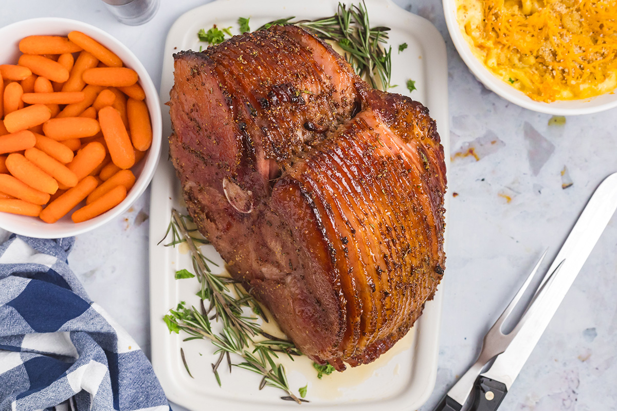 overhead shot of sliced mustard brown sugar ham on cutting board