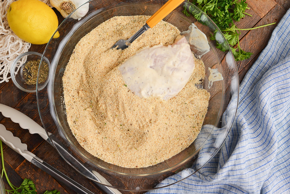 chicken dredged in bowl of breadcrumbs