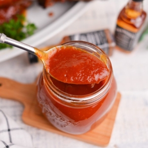 angled shot of spoon in jar of jack daniels bbq sauce