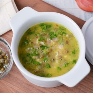 angled shot of bowl of lemon caper sauce