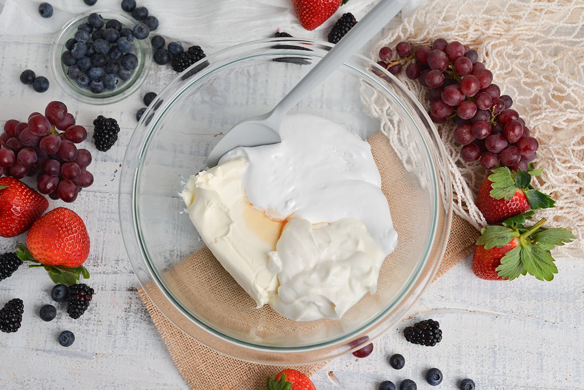 ingredients for marshmallow fruit dip in a glass mixing bowl