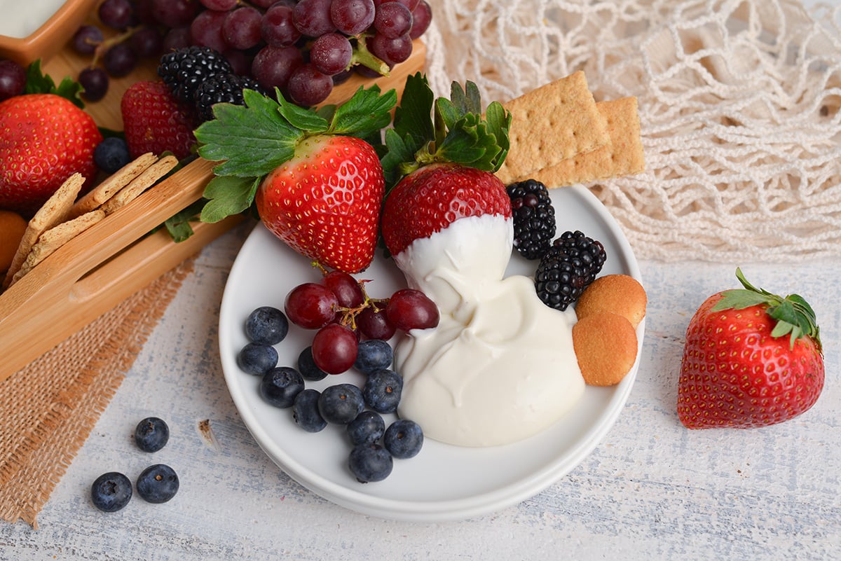 fresh fruit on a plate with marshmallow fruit dip, graham crackers and nilla wafers