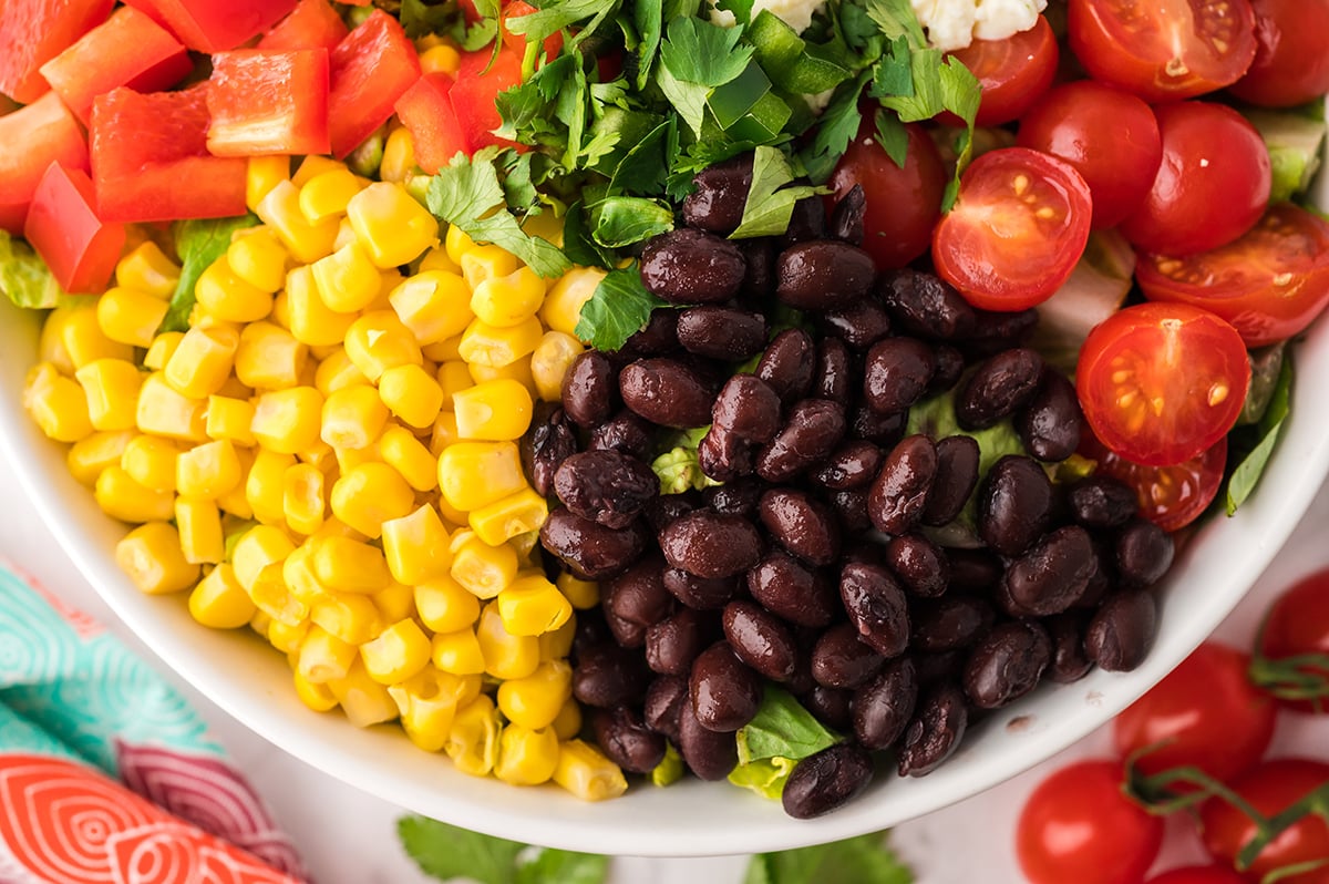 close up of black beans, corn and tomatoes on salad