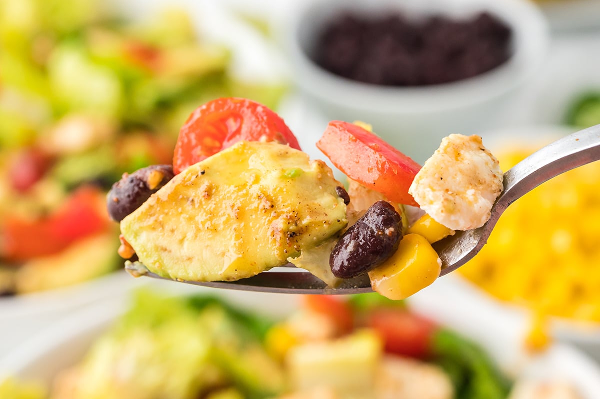 close up of bite of mexican salad on fork