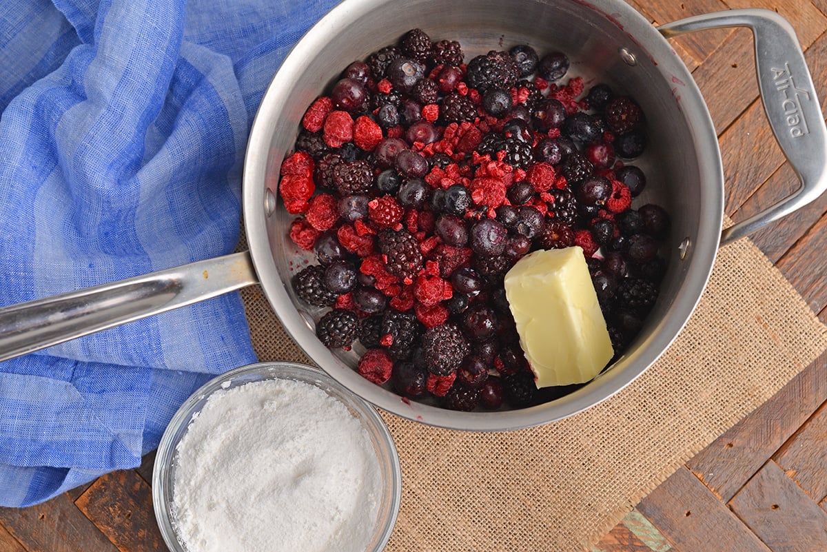 overhead shot of berried in pot with butter